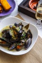 Freshly cooked mussels with vegetables and herbs in wine sauce