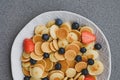 Freshly cooked pancake cereal served with fresh berries, top view.