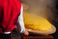 Freshly cooked polenta, still steaming overturned on the appropriate wooden cutting board, according to the tradition