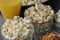 Freshly cooked popcorn in bowl and a glass of juice Royalty Free Stock Photo