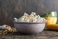 Freshly cooked popcorn in a bowl on a wooden table. Royalty Free Stock Photo