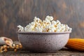 Freshly cooked popcorn in a bowl on a wooden table. Royalty Free Stock Photo