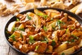 Freshly cooked potato wedges with wild chanterelle mushrooms close-up on a plate. horizontal Royalty Free Stock Photo