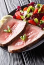 Freshly cooked rare beef steak with fresh vegetable salad close-up on a plate. vertical Royalty Free Stock Photo