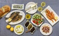 Freshly cooked seafood grilled sea bream fishes, fried red mullets, octopus in vinegar sauce, sardines in olive oil and Royalty Free Stock Photo