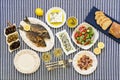Freshly cooked seafood grilled sea bream fishes, octopus in vinegar sauce, sardines in olive oil and vegetable salad Royalty Free Stock Photo