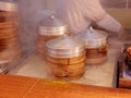 Freshly cooked steamed buns and dumplings for sale in Yuyuan garden, Shanghai, stacks of bamboo food steamer with wihte vapor Royalty Free Stock Photo