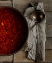 Freshly cooked traditional Russian anf Ukranian beetroot soup borcht in a pan on wooden rustic background, closeup view Royalty Free Stock Photo