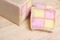 Freshly cut Battenberg Cake with pink and yellow sponge covered in marzipan Royalty Free Stock Photo