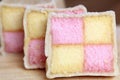 Freshly cut Battenberg Cake slices with pink and yellow sponge covered in marzipan Royalty Free Stock Photo