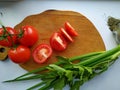 Freshly cut celery, tomatoes, green onion on wooden cutting board Royalty Free Stock Photo