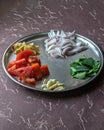 Freshly cut , colorful ingredients of Indian food just before cooking. Tomato, Ginger, Onion, Garlic and Curry leaves Royalty Free Stock Photo