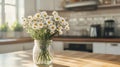 Freshly cut flowers in a simple glass jar on a kitchen counter. Royalty Free Stock Photo