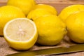 Freshly cut lemons on a ocher texture with a knife