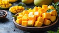 Freshly cut mango cubes on a wooden plate Royalty Free Stock Photo