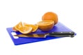 Freshly cut orange pieces on chopping board