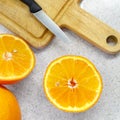 Freshly cut ripe juicy orange lies on a table