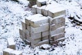 Freshly fallen snow on a building material a pile of bricks