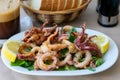Freshly fried crunchy shrimps, octopuses, calamari, mussels decorated by lemon slices and parsley.