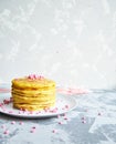 Freshly fried French pancakes on a plate on a light background