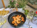 Freshly fried scampi with salad, white bread and a glass of white wine.