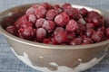 Freshly frozen red cherry berries in a metal bowl
