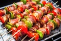 freshly grilled brussels sprouts and bacon skewers on aluminium foil