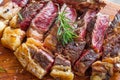 Sliced grilled vaca rubia gallega steak on wooden board with seasonings