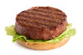 Freshly grilled plant based burger patty on bun with lettuce and sauce isolated on white Royalty Free Stock Photo