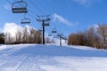 A freshly groomed run with a chairlift at a ski hill