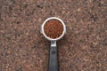 Freshly ground coffee beans in a metal filter Royalty Free Stock Photo