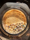 Freshly ground coffee bloomig in an aeropress close-up, manual brewing method Royalty Free Stock Photo