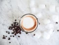 Freshly ground coffee beans with ICE and cappuccino cup