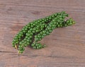 Freshly ground pepper  sheeds  on a wooden background Royalty Free Stock Photo