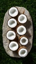 Freshly halved coconuts arranged artistically on a natural stone