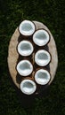 Freshly halved coconuts arranged artistically on a natural stone