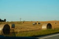 The freshly harvested grain field. Field of freshly bales of hay with beautiful sunset Royalty Free Stock Photo