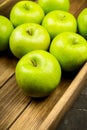 Freshly harvested green apples in the wooden crate. Selective focus Royalty Free Stock Photo