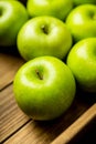 Freshly harvested green apples in the wooden crate. Selective focus Royalty Free Stock Photo