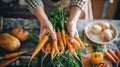 Freshly harvested organic carrots held by a person in a home kitchen Royalty Free Stock Photo