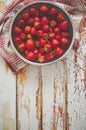 Freshly harvested strawberries. Metal colander filled with juicy fresh ripe strawberries on an table