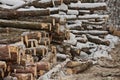 Freshly Harvested Timber from a Logging Operation Piled by the Forest in Winter