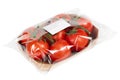 Freshly harvested tomatoes packaged and labeled on isolated white background