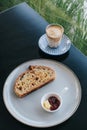 Freshly homemade baked sour dough rye bread sliced and served with jam and butter on white plate and coffee Royalty Free Stock Photo