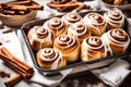 Freshly homemade Cinnamon rolls or Cinnamon buns close-up. Traditional sweet dessert buns with white cream sauce