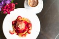 Freshly homemade Pancakes Strawberry Crumble on white dessert plate