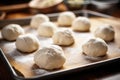 freshly kneaded dough balls ready to be shaped into pretzels