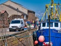 Freshly landed fish being sold at the crowded quayside at Maryport on the Solway Coast in Cumbria, UK.