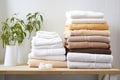 freshly laundered towels stacked neatly on a bathroom shelf