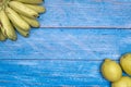 Freshly lemons and banana on rustic blue board background